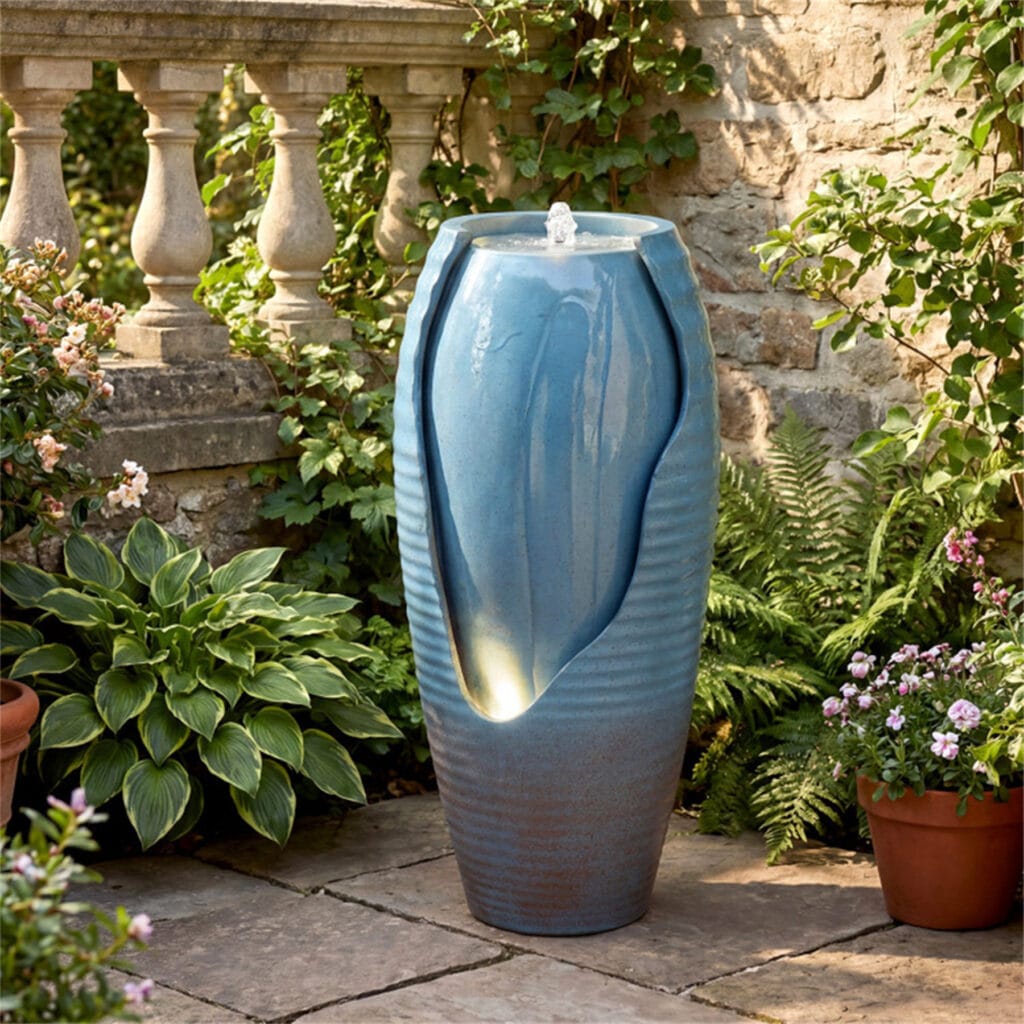 16x32 cracked jar LED water fountain placed in backyard garden corner beside potted plants